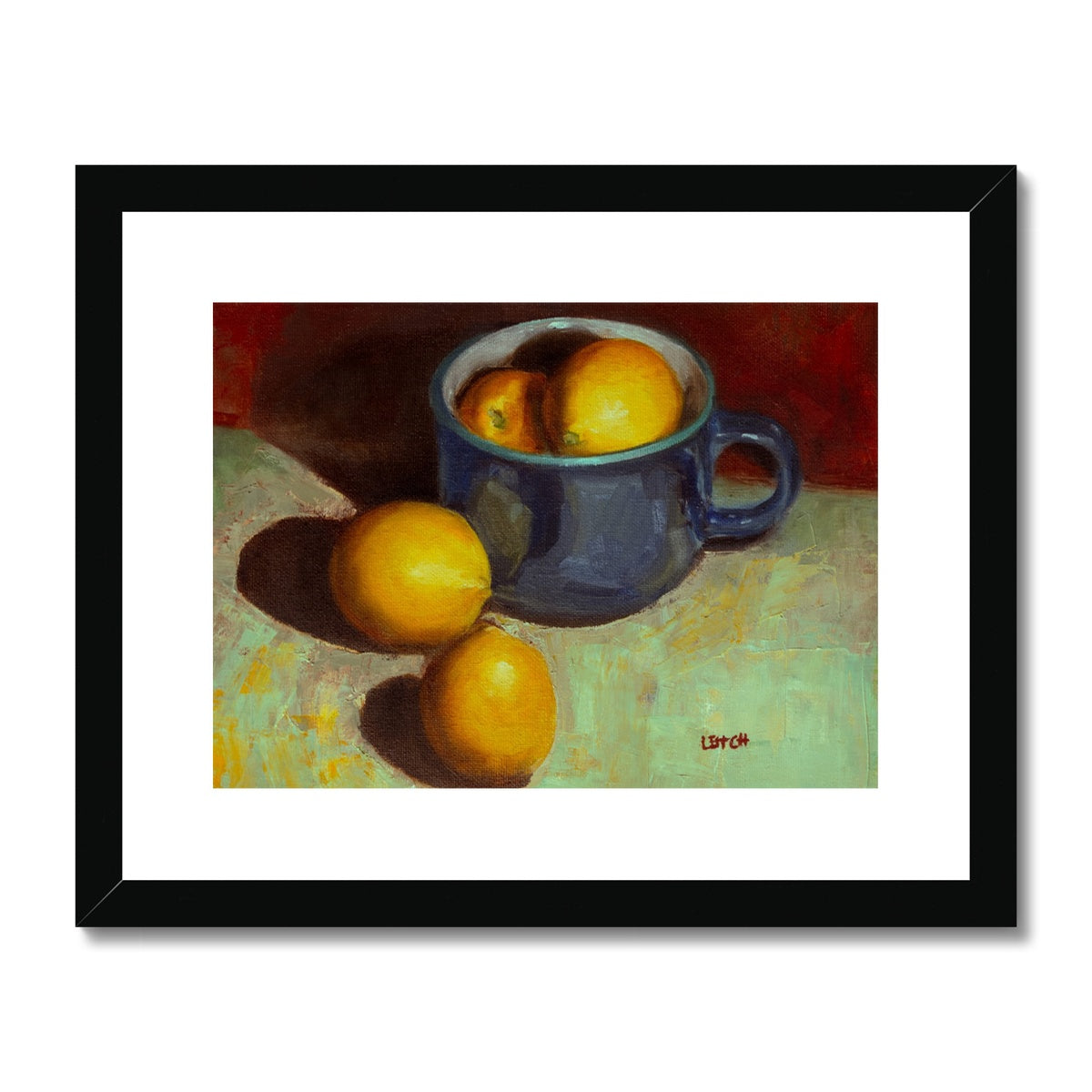 A rich blue teacup reflects bright sunlight. Whole lemons are in the cup and two are on the table beside it. The lemons contrast boldly against the intense blue and maroon backdrop.