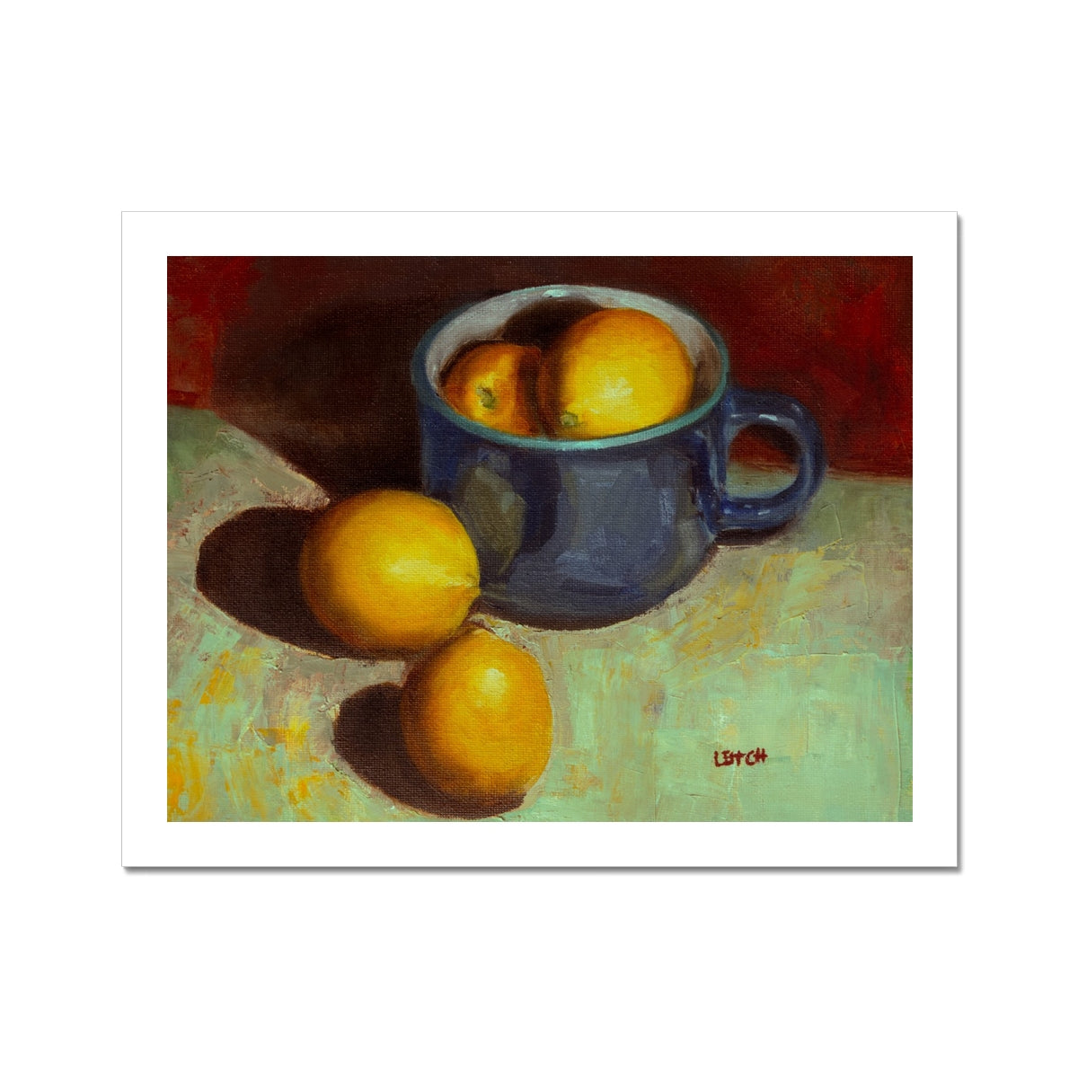 Painting of lemons sitting in and beside a blue teacup. Unframed print with white border.